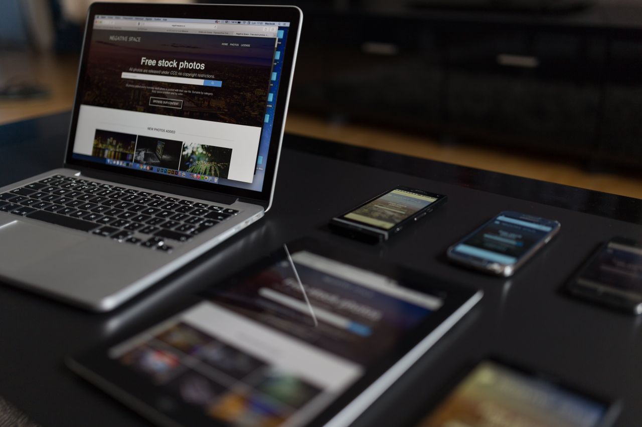 A modern work area displaying a laptop, tablet, and smartphones, well suited for technology and freelance tasks.